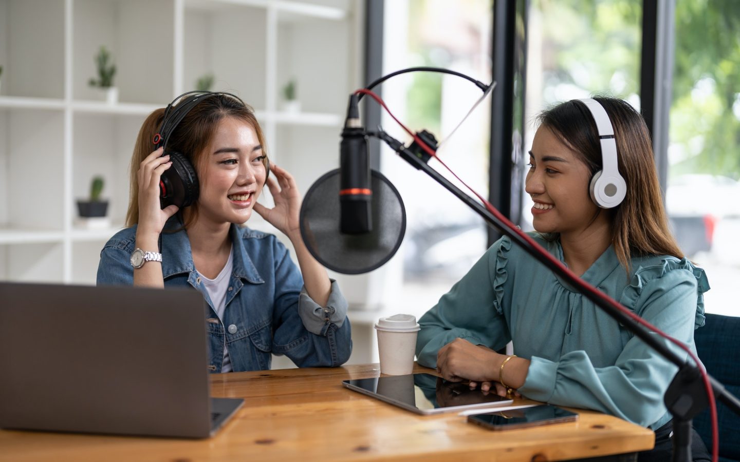 two-asian-radio-podcasters-recording-interview-each-other-for-radio-podcast-.jpg